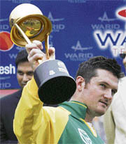South African captain Graeme Smith holds the trophy after his team swept the ODI series against Bangladesh in Dhaka on Friday.