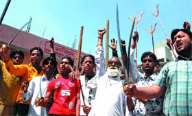 Activists of the VHP and the Bajrang Dal brandishing swords at a march held in Bathinda