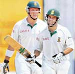 South Africa�s Neil McKenzie (R) celebrates on completing his fifty as captain Graeme Smith looks on during the first day of the first Test at the Chepauk Stadium in Chennai 