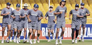 Indian cricketers warm up during a training session ahead of the second Test match between India and South Africa in Ahmedabad