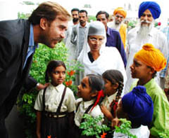 Ansar Burney (left) interacts with kids at the Old Age Home in village Badal in Muktsar district on Thursday.