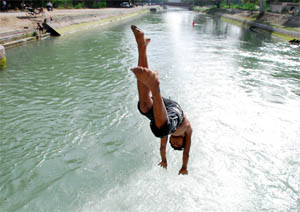 To cool himself, a boy dives into the Sirhind canal in Bathinda.