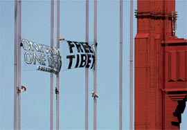 Anti-China protesters hang banners as they scale the cables of the Golden Gate Bridge in San Francisco, California, on Monday. The city of San Francisco prepares to host the Olympic Torch relay on Wednesday. 