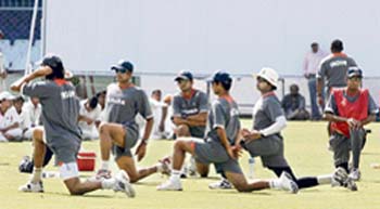 Indian cricketers stretch during a training session ahead of the third and final Test match between India and South Africa at the Green Park stadium in Kanpur 