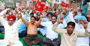 Members of the Technical Services Union raise slogans at a dharna staged in front of the DC office in Bathinda on Thursday.