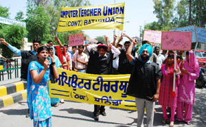 Members of the Computer Teachers� Union press for their demands in Bathinda on Saturday. 