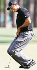 Tiger Woods reacts to a missed birdie putt on the 8th green during the second round of the 2008 Masters golf tournament.