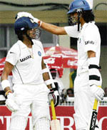 S. Sreesanth (L) is congratulated by teammate Ishant Sharma after hitting a ball to the boundary during the third day of the final Test at the Green Park stadium in Kanpur on Sunday.