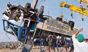The damaged bus, which fell from a 60-ft-high bridge into the Narmada canal, being pulled out at Bodeli village in Vadodara district on Wednesday.