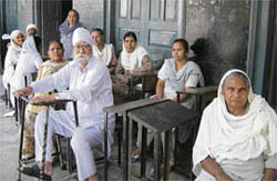 Pension seekers wait at a camp which was later cancelled in view of the election code of conduct in the Amritsar South constituency on Thursday.