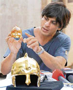 Owner of IPL�s Kolkata Knight Riders Shahrukh Khan unveils an 18-carat gold-plated helmet and a diamond studded helmet in Mumbai