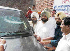 Former Chief Minister Amarinder Singh inspects Gurdaspur zila parishad member Parminder Singh Sabi�s vehicle, which was damaged allegedly by musclemen of the Fatehgarh Churian MLA, at Rahimabad village, near Dera Baba Nanak, on Saturday. 