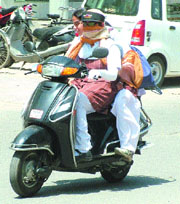 With mercury rising, the city students are using different gears to protect themselves from the heat wave.