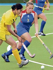 Jasjeet Kaur Handa (L) of India vies for the ball with Athea Richard of France during their women's hockey Olympic qualifying match in Kazan, Russia, on Saturday.