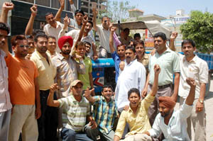 Vehicle dealers raising slogans against Improvement Trust onBathinda-Goniana road in Bathinda on Sunday.