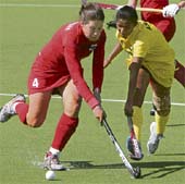 Asunta Lakra (R) of India vies for ball with Therese Noorlander of Netherlands Antilles during their women�s field hockey Olympic qualifying match for third place in Kazan on Sunday. 