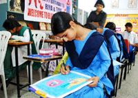 Students of several school participating in a slogan writing contest at the Swami Vivekananda Girls College in Bathinda on Monday.
