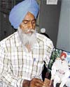 Chand Singh with a photograph of his son Dharminder Singh