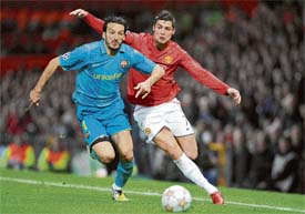 Manchester United�s Portuguese midfielder Cristiano Ronaldo (R) fouls Barcelona�s Italian defender Gianluca Zambrotta during their UEFA Champions League second leg football match on Tuesday at Old Trafford