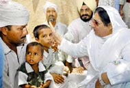 PPCC chief Rajinder Kaur Bhattal consoles two minor boys whose mother and sister were burnt alive in the fire at Midhu-Khera