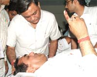 BJP minister Manoranjan Kalia enquiring about the well-being of BJP leader D.P. Chandan who was injured by SAD activists at village Burj Gill during polling