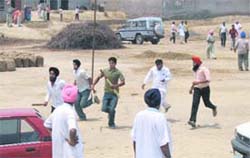 SAD activists chase away Congress supporters at a polling booth at Lambi village, the constituency of Chief Minister Parkash Singh Badal, in Muktsar district on Monday