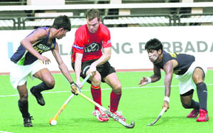 Belgium�s Charles Vandeweghe (C) battles for the ball against India�s Sarvanjit Singh (L) and Innocent Kullu during their match at the 17th Sultan Azlan Shah Cup in Ipoh, Malaysia on Monday. 