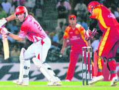 Kings XI Punjab opener Shaun Marsh, who scored unbeaten 74, in action against Bangalore Royal Challengers in the IPL T20 match at PCA Stadium in Mohali on Monday.