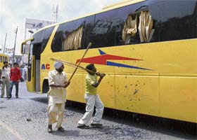 Activists of the BJP break windowpanes of a bus of the Orbit company, belonging to the Badal family, in Bathinda
