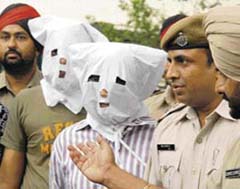 Police officials with the accused in the burglary in Ludiana on Tuesday.