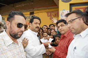 PYC workers led by Vijay Inder Singla their president seizes slips for free atta to voters in Amritsar on Wednesday.
