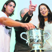 Spanish Rafael Nadal (L) picks up a card, next to Serbian Ana Ivanovic (R) during the draw ahead of the start of the French Open, in Paris, on Friday.