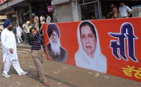 A boy employed to carry the flex board, featuring CM Parkash Singh Badal and Bathinda MP Parminder Kaur Gulshan, outside the venue, where the CM was scheduled to address a meeting at Goniana Mandi in Bathinda district
