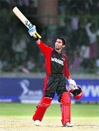 Delhi Daredevils' Dinesh Karthik acknowledges the crowd after completing his against Mumbai Indians during the IPL T20 match at Ferozshah Kotla stadium in New Delhi