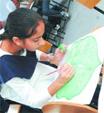 A student of Manav Sehyog School paints a leave on  World Environment Day in Jalandhar on Thursday.