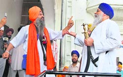 Jathedar of Takht Patna Sahib Giani Iqbal Singh (right) being stopped from attending a meeting of Sikh clergy at Akal Takht in Amritsar on Friday. Photo: Vishal Kumar