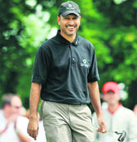 Indian Golfer Jeev Milkha Singh smiles after finishing in the lead at the first round of the Bank Austria Golf Open at Vienna on Saturday.
