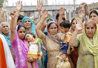 Residents of Maadh village protest their forced migration from the village, in Amritsar on Wednesday.