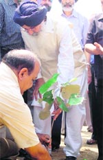Punjab Chief Minister Parkash Singh Badal plants a sapling after laying the foundation stone of Rajiv Gandhi National University of Law at Sidhuwal village near Patiala