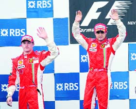 Ferrari�s Finnish driver Kimi Raikkonen (L) and Ferrari Brazilian�s driver Felipe Massa celebrate on the podium of the Magny-Cours racetrack