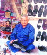 Om Parkash Jakhu polishes shoes at his shop in Hoshiarpur.