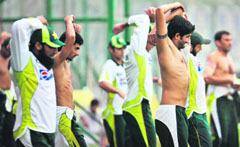 Pakistan cricketers warm up during the practice session at the National Stadium in Karachi.