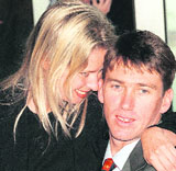 This file photo taken on May 10, 1997, shows Glenn McGrath (R) hugging his future wife Jane McGrath before departing from Sydney International Airport for the Ashes tour.