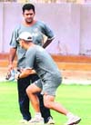 Coach Gary Kirsten gives tips to Mahendra Singh Dhoni (L) during a practice session in Karachi