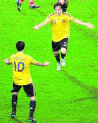 Spanish midfielder Cesc Fabregas and David Silva celebrate at the end of their semifinal match against Russia at Ernst-Happel stadium in Vienna, Austria