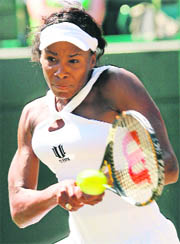 US� Venus Williams returns the ball to her Thai opponent Tamarine Tanasugarn during their quarterfinal match at the Wimbledon championships in London on Monday. 