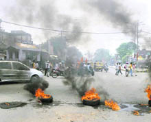 Burning tyres put up by activists of the Bajrang Dal and Shiv Sena near the Hall Gate in Amritsar on Thursday.