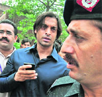 Pakistani pacer Shoaib Akhtar (C) comes out of a court building after filing an appeal in Lahore on Friday.
