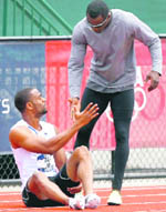 Tyson Gay (L) shakes hands with John Capel after injuring his leg in a men's 200 meters quarter-final heat at the U.S. Olympic Track and Field Trials in Eugene, Oregon, on Saturday. 