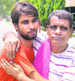 Indian national Ram Prakash (right), who was released from a Pakistani jail, is hugged by his son at the Wagah check-post in Amritsar